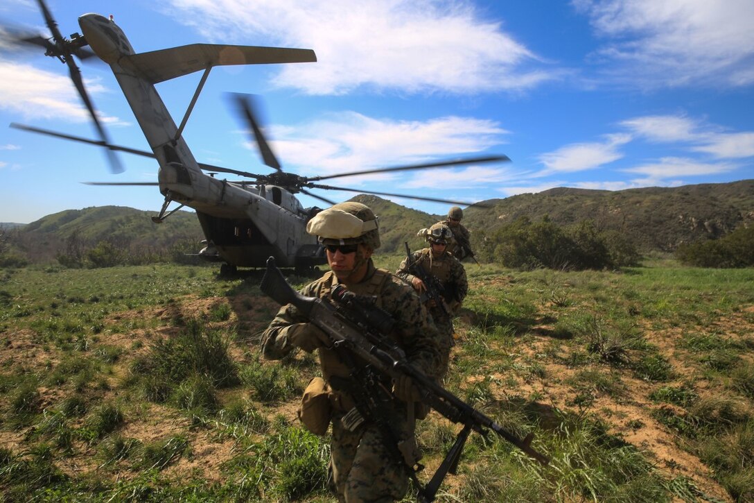 Marines offload from a CH-53E Super Stallion transport helicopter to retrieve a simulated injured pilot during a tactical recovery of aircraft and personnel, or TRAP, training scenario at Camp Pendleton, Calif., Feb. 10, 2016. In preparation for their upcoming deployment with the 31st Marine Expeditionary Unit, the TRAP scenario offers the Marines of 2nd Battalion, 4th Marine Regiment, 1st Marine Division, a secondary skillset above their own primary duties as a 81mm mortar platoon, refining their ability to efficiently conduct a recovery mission. (U.S. Marine Corps photo by Lance Cpl. Devan K. Gowans/Released)