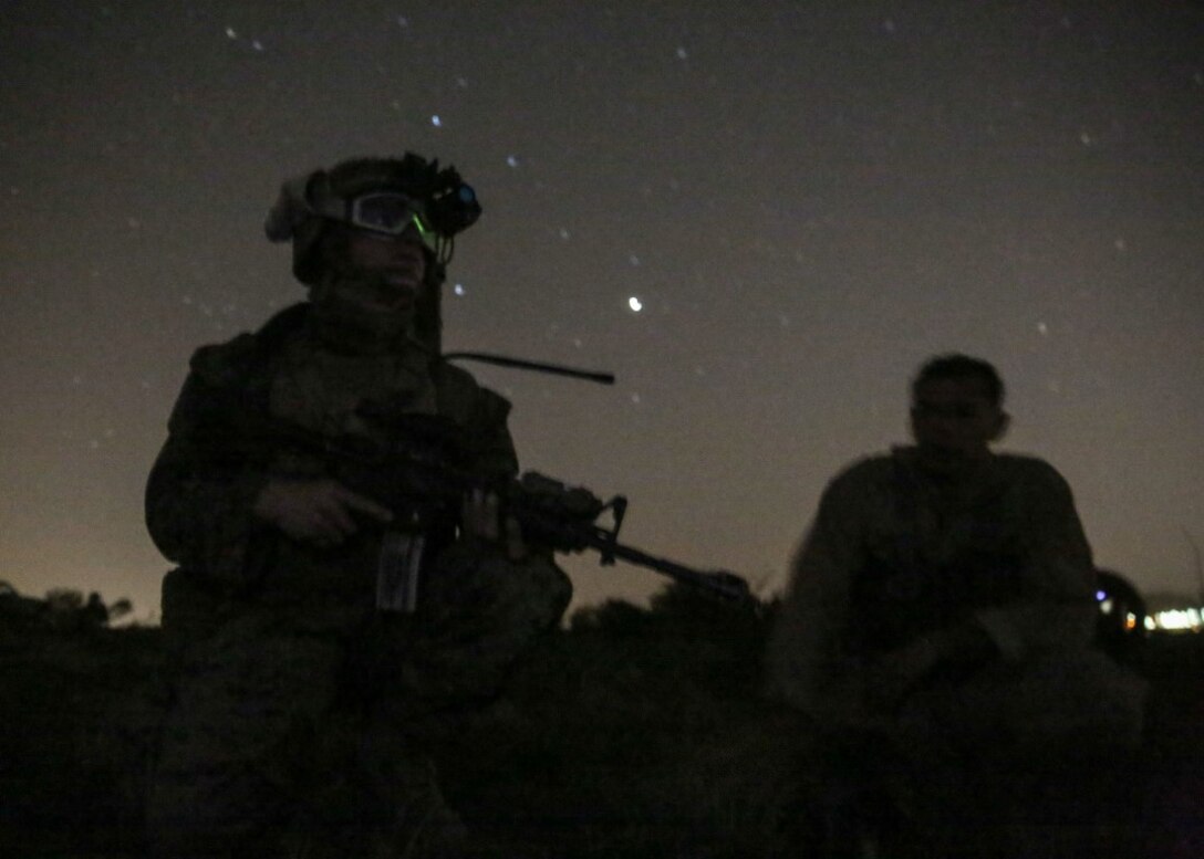 A Marine secures the simulated downed pilot and awaits extraction during the night portion of a tactical recovery of aircraft and personnel, or TRAP, training scenario at Camp Pendleton, Calif., Feb. 8, 2016. TRAP is used to tactically recover personnel, equipment or aircraft by inserting a recovery force to the objective location. The Marine is with 2nd Battalion, 4th Marine Regiment, 1st Marine Division. (U.S. Marine Corps photo by Lance Cpl. Devan K. Gowans/Released)