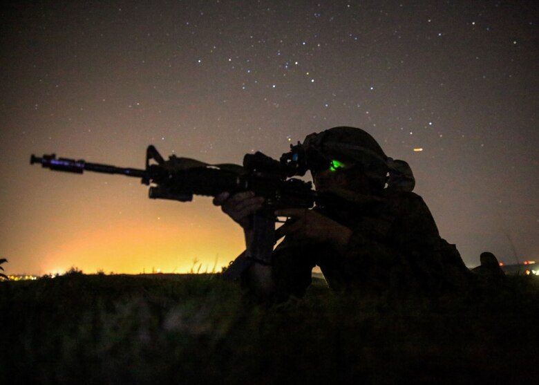 A Marine provides security for his team during the night portion of a tactical recovery of aircraft and personnel, or TRAP, training scenario at Camp Pendleton, Calif., Feb. 8, 2016. TRAP is used to tactically recover personnel, equipment or aircraft by inserting the recovery force to the objective location. The Marine is with Weapons Company, 2nd Battalion, 4th Marine Regiment, 1st Marine Division. (U.S. Marine Corps photo by Lance Cpl. Devan K. Gowans/Released)