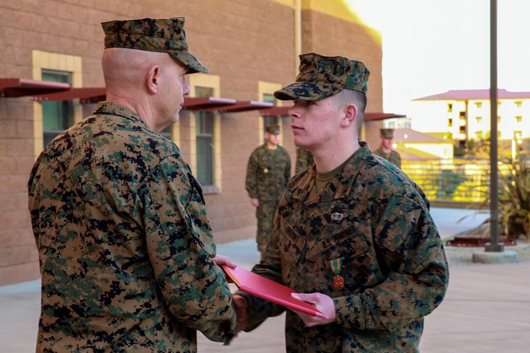 Cpl. Corey Mount is recognized by Lt. Gen. David Berger as the I Marine Expeditionary Force Marine of the Year during a ceremony at Camp Pendleton Feb. 10, 2016. The award recognizes a Marine who exceeds expectations and embodies the spirit and ideals of the Marine Corps. Berger is the I MEF commanding general and Mount, a native of Indianapolis, is an administrative noncommissioned officer with 1st Reconnaissance Battalion, 1st Marine Division, I MEF. (U.S. Marine Corps photo by Lance Cpl. Caitlin Bevel)
