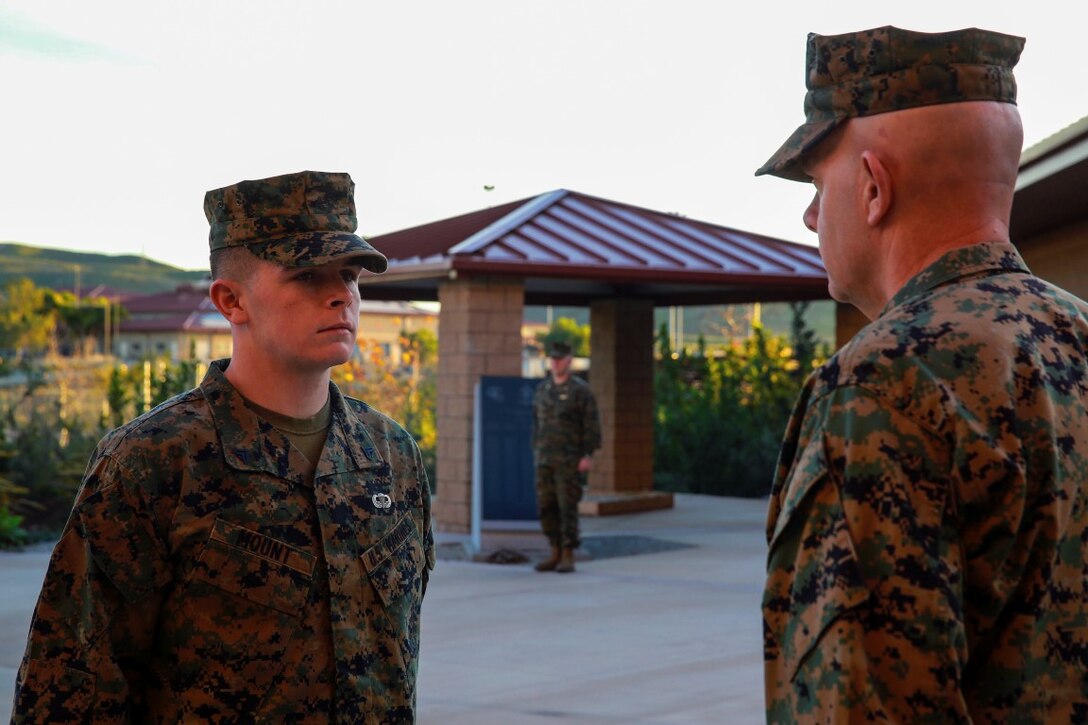 Cpl. Corey Mount is recognized by Lt. Gen. David Berger as the I Marine Expeditionary Force Marine of the Year during a ceremony at Camp Pendleton Feb. 10, 2016. The award recognizes a Marine who exceeds expectations and embodies the spirit and ideals of the Marine Corps. Berger is the I MEF commanding general and Mount, a native of Indianapolis, is an administrative noncommissioned officer with 1st Reconnaissance Battalion, 1st Marine Division, I MEF. (U.S. Marine Corps photo by Lance Cpl. Caitlin Bevel)