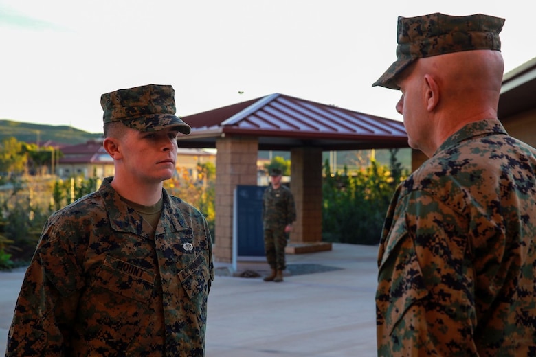 Cpl. Corey Mount is recognized by Lt. Gen. David Berger as the I Marine Expeditionary Force Marine of the Year during a ceremony at Camp Pendleton Feb. 10, 2016. The award recognizes a Marine who exceeds expectations and embodies the spirit and ideals of the Marine Corps. Berger is the I MEF commanding general and Mount, a native of Indianapolis, is an administrative noncommissioned officer with 1st Reconnaissance Battalion, 1st Marine Division, I MEF. (U.S. Marine Corps photo by Lance Cpl. Caitlin Bevel)