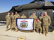 West Virginia Army National Guard Chief Warrant Officer 4 Lawrence Copley (far right) and his son Chief Warrant Officer 2 Joseph Copley (far left), get together with some of their fellow Soldiers from 2nd Battalion, 104th Aviation Regiment, 40th Combat Aviation Brigade, get some quality time together shortly after Joseph’s promotion at Camp Buehring Kuwait, Jan. 30. The Copleys deployed with the 40th CAB to Kuwait in December. (Courtesy Photo)