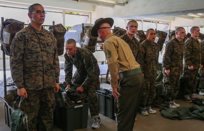 Staff Sgt. Mitchell M. Goldschmidt, drill instructor, Kilo Company, 3rd Recruit Training Battalion, corrects a recruit for not following directions during pick up at Marine Corps Recruit Depot San Diego, Feb. 12. During pick up, recruits were introduced to the fast-paced rigors and intensity they will endure over the next 12 weeks. Annually, more than 17,000 males recruited from the Western Recruiting Region are trained at MCRD San Diego. Kilo Company is scheduled to graduate May 6.