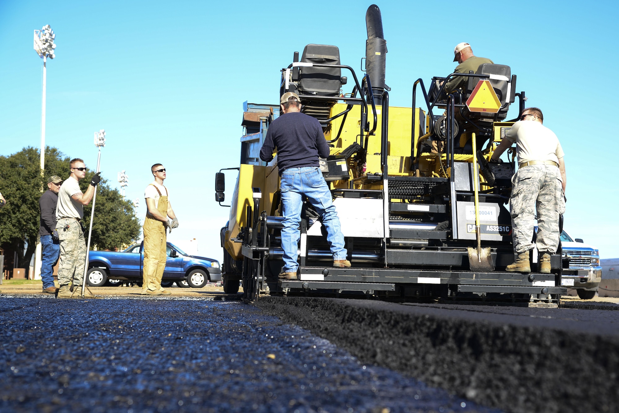 The 2nd Civil Engineer Squadron pavement and equipment flight, also known as the Dirtboys, replace asphalt near the flightline at Barksdale Air Force Base, La., Feb. 11, 2016. The paving project also served as a training opportunity to give the Airmen experience with pavers and rollers, which they could also use in deployed locations. (U.S. Air Force photo/Senior Airman Benjamin Raughton)