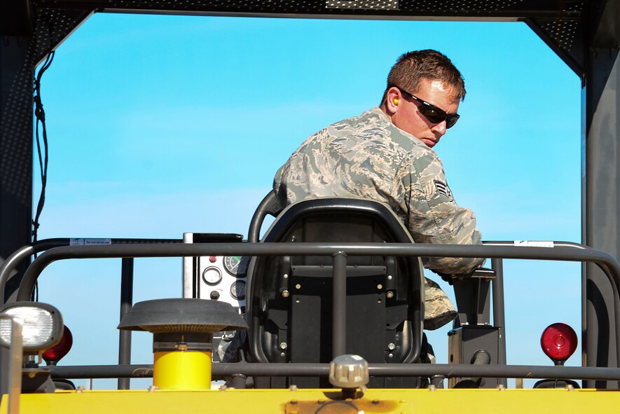Senior Airman Jeremy Bisaccio, 2nd Civil Engineer Squadron Dirtboys heavy equipment operator, backs a roller over fresh asphalt at Barksdale Air Force Base, La., Feb. 11, 2016. The roller flattened fresh asphalt which solidified to give drivers an even surface. (U.S. Air Force photo/Senior Airman Benjamin Raughton)