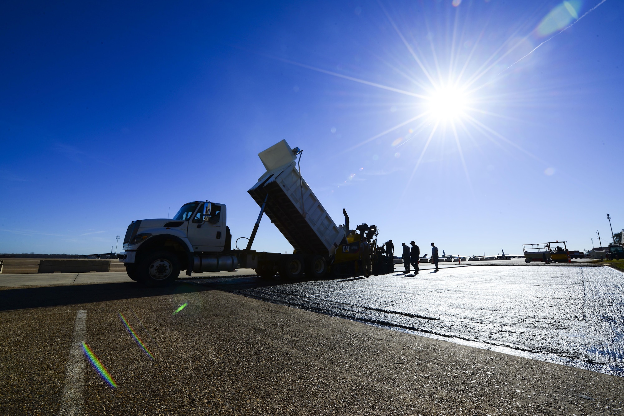 The 2nd Civil Engineer Squadron pavement and equipment flight, also known as the Dirtboys, replace asphalt near the flightline at Barksdale Air Force Base, La., Feb. 11, 2016. Ground Equipment was bringing debris to the flightline, so the asphalt was replaced to reduce the risk of debris impacting airfield operations. (U.S. Air Force photo/Senior Airman Benjamin Raughton)