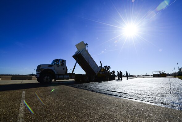 The 2nd Civil Engineer Squadron pavement and equipment flight, also known as the Dirtboys, replace asphalt near the flightline at Barksdale Air Force Base, La., Feb. 11, 2016. Ground Equipment was bringing debris to the flightline, so the asphalt was replaced to reduce the risk of debris impacting airfield operations. (U.S. Air Force photo/Senior Airman Benjamin Raughton)