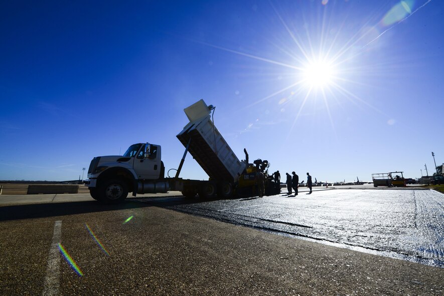 The 2nd Civil Engineer Squadron pavement and equipment flight, also known as the Dirtboys, replace asphalt near the flightline at Barksdale Air Force Base, La., Feb. 11, 2016. Ground Equipment was bringing debris to the flightline, so the asphalt was replaced to reduce the risk of debris impacting airfield operations. (U.S. Air Force photo/Senior Airman Benjamin Raughton)
