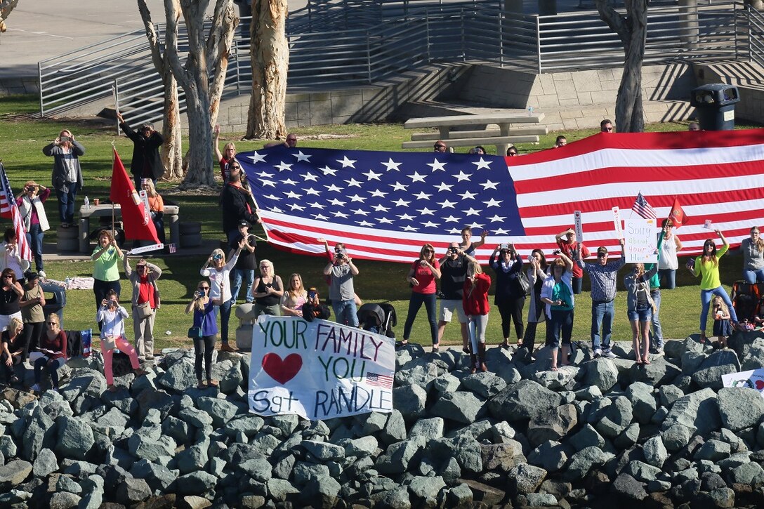 U.S. Marines and Sailors with the 13th Marine Expeditionary Unit line the flight deck of the USS Boxer as the ship shoves off from Naval Base San Diego, Feb. 12, 2016. Their departure Marks the official start of Western Pacific Deployment 16-1. Families of the deploying troops waved and shouted to the ship from land as it passed through the harbor. (U.S. Marine Corps photo by Sgt. Paris Capers/Released)