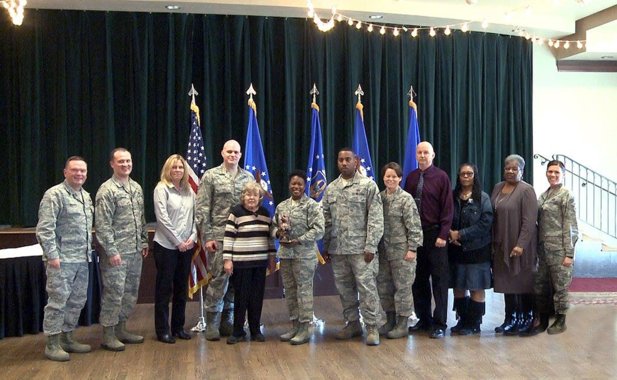 Brig. Gen. Samuel “Bo” Mahaney, Air Reserve Personnel Center commander, and Chief Master Sgt. Ruthe Flores, ARPC command chief, present the ARPC Team of the Year award to members from the Individual Readiness Reserve Muster Team. Mahaney honored ARPC’s 2015 outstanding performers of the year Feb. 16, 2016, at the Heritage Eagle Bend Country Club in Aurora, Colo.(U.S. Air Force photo/Quinn Jacobson)