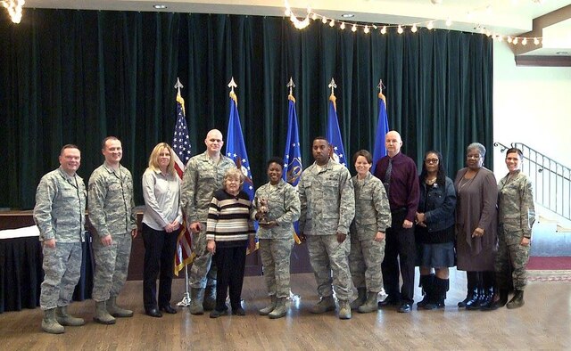 Brig. Gen. Samuel “Bo” Mahaney, Air Reserve Personnel Center commander, and Chief Master Sgt. Ruthe Flores, ARPC command chief, present the ARPC Team of the Year award to members from the Individual Readiness Reserve Muster Team. Mahaney honored ARPC’s 2015 outstanding performers of the year Feb. 16, 2016, at the Heritage Eagle Bend Country Club in Aurora, Colo.(U.S. Air Force photo/Quinn Jacobson)