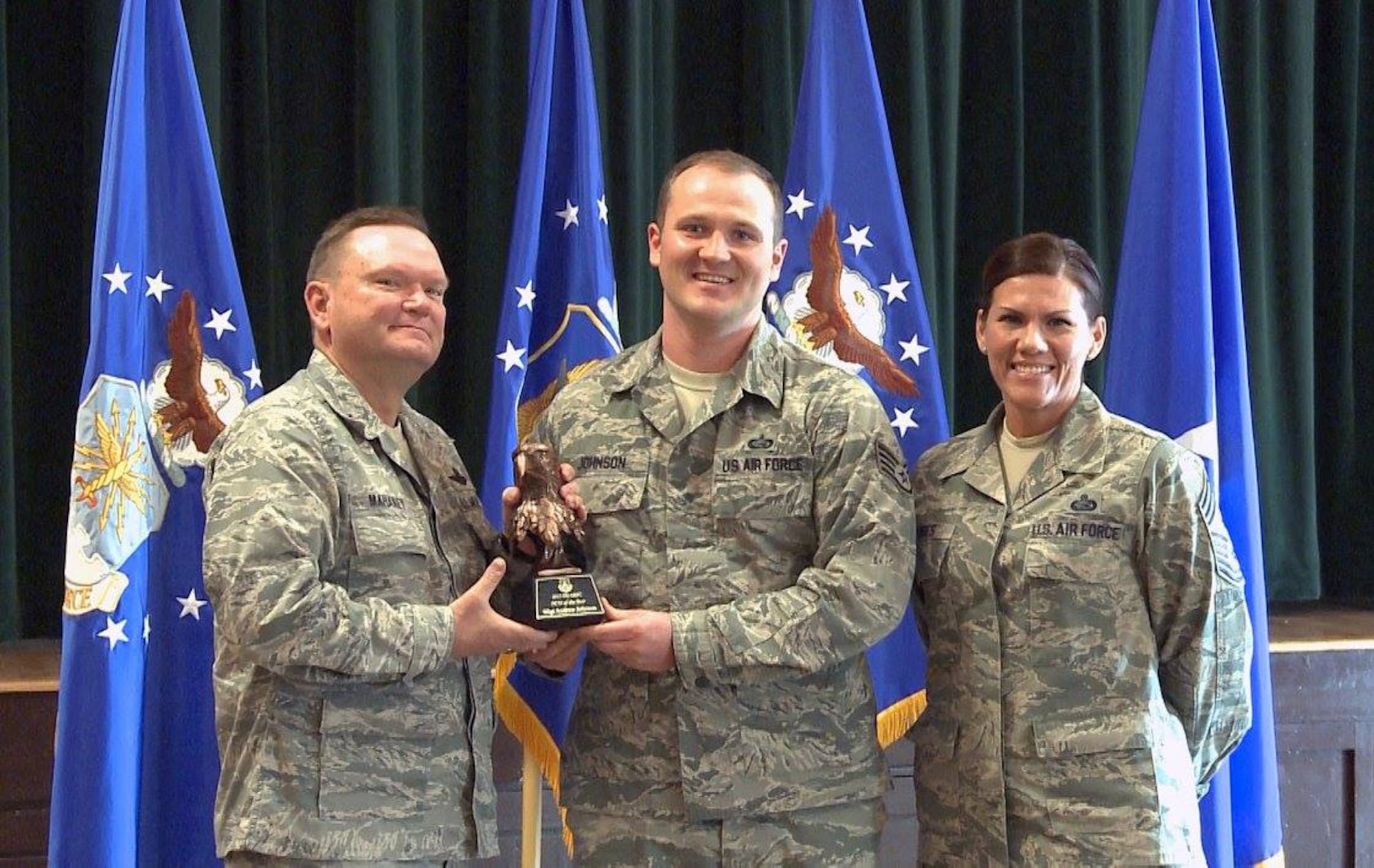 Brig. Gen. Samuel “Bo” Mahaney, Air Reserve Personnel Center commander, and Chief Master Sgt. Ruthe Flores, ARPC command chief, present the ARPC Noncommissioned Officer of the Year award to Staff Sgt. Andrew Johnson. Mahaney honored ARPC’s 2015 outstanding performers of the year Feb. 16, 2016, at the Heritage Eagle Bend Country Club in Aurora, Colo. (U.S. Air Force photo/Quinn Jacobson)