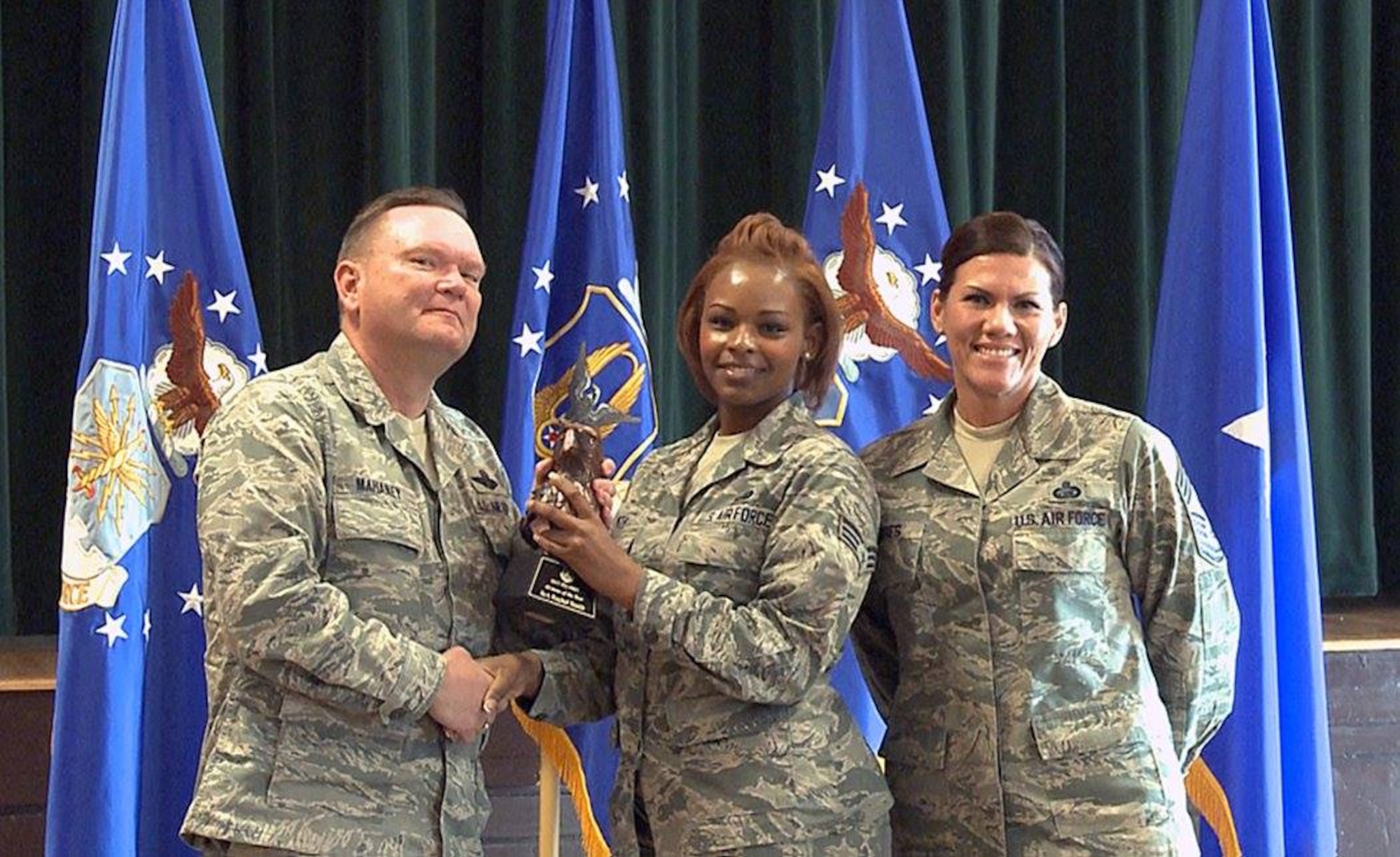 Brig. Gen. Samuel “Bo” Mahaney, Air Reserve Personnel Center commander, and Chief Master Sgt. Ruthe Flores, ARPC command chief, present the ARPC Airman of the Year award to Senior Airman Rachel Smith. Mahaney honored ARPC’s 2015 outstanding performers of the year Feb. 16, 2016, at the Heritage Eagle Bend Country Club in Aurora, Colo. (U.S. Air Force photo/Quinn Jacobson)