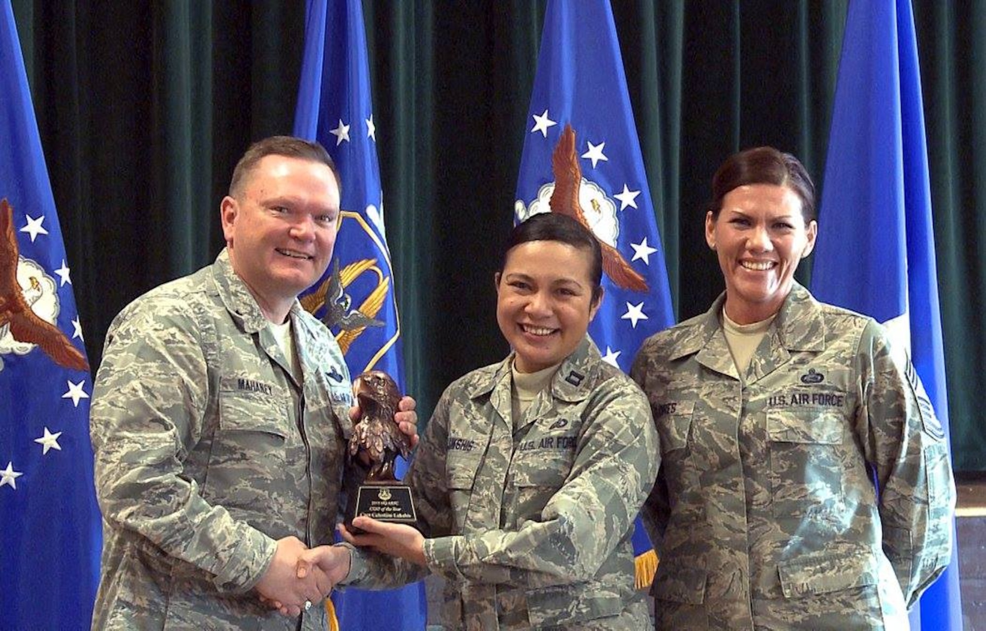 Brig. Gen. Samuel “Bo” Mahaney, Air Reserve Personnel Center commander, and Chief Master Sgt. Ruthe Flores, ARPC command chief, present the ARPC Company Grade Officer of the Year award to Capt. Celestine Lukshis. Mahaney honored ARPC’s 2015 outstanding performers of the year Feb. 16, 2016, at the Heritage Eagle Bend Country Club in Aurora, Colo. (U.S. Air Force photo/Quinn Jacobson)