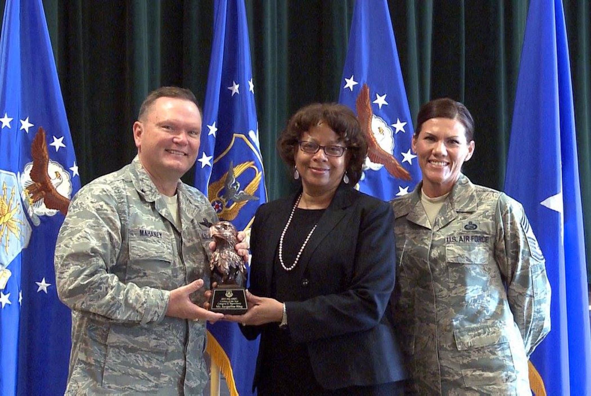 Brig. Gen. Samuel “Bo” Mahaney, Air Reserve Personnel Center commander, and Chief Master Sgt. Ruthe Flores, ARPC command chief, present the Category II, Supervisory Civilian of the Year award to Jacqueline Bing. Mahaney honored ARPC’s 2015 outstanding performers of the year Feb. 16, 2016, at the Heritage Eagle Bend Country Club in Aurora. Colo. (U.S. Air Force photo/Quinn Jacobson)
