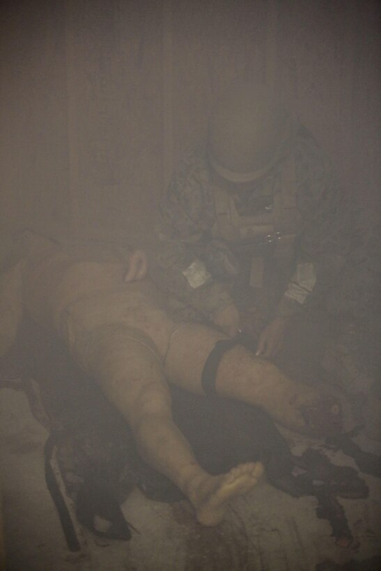U.S. Navy Seaman Andre Hall, a hospitalman with 2nd Medical Battalion, locates a casualty during a tactical combat casualty care exercise at Camp Lejeune, N.C., Feb. 12, 2016. Sailors were challenged by a chaotic environment of smoke and loud, sporadic noises. (U.S. Marine Corps photo by Cpl. Paul S. Martinez/Released)