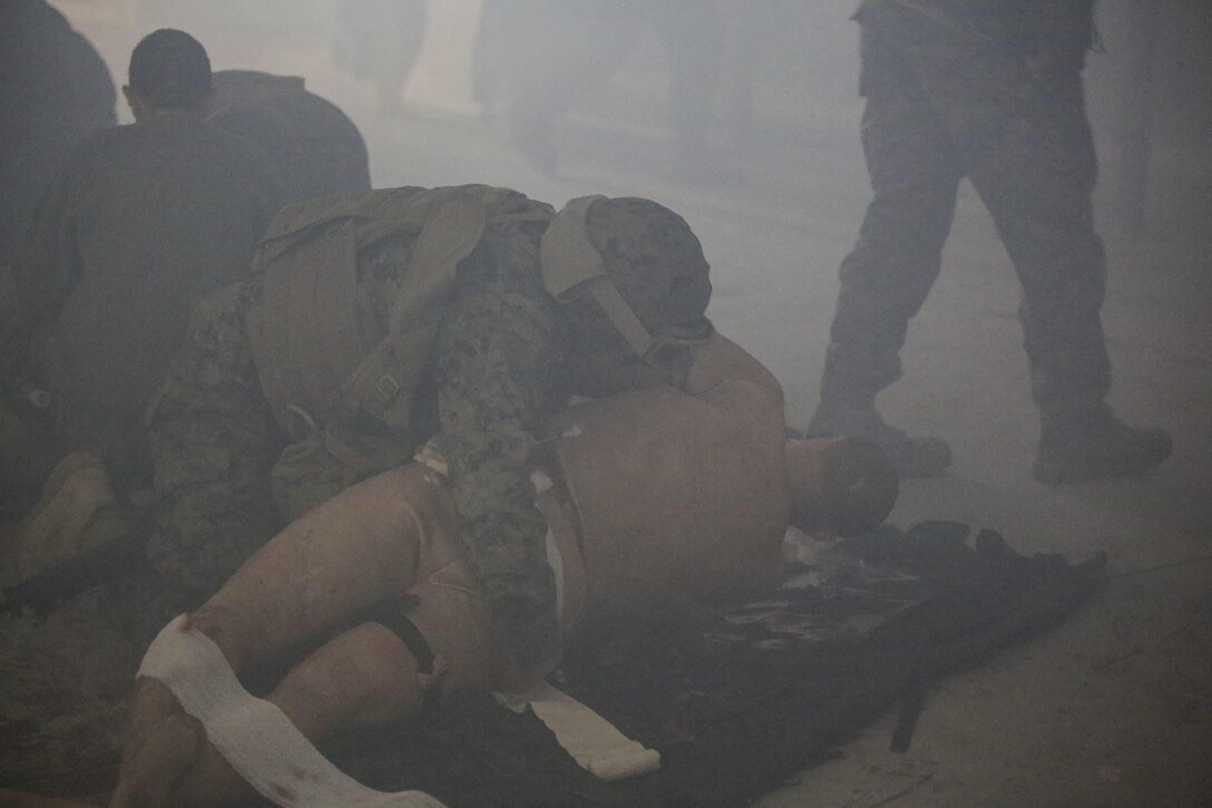 U.S. Navy Seaman Justin Phares, a hospitalman with 2nd Medical Battalion, treats a casualty during a tactical combat casualty care exercise at Camp Lejeune, N.C., Feb. 12, 2016. Sailors were challenged by a chaotic environment of smoke and loud, sporadic noises. (U.S. Marine Corps photo by Cpl. Paul S. Martinez/Released)