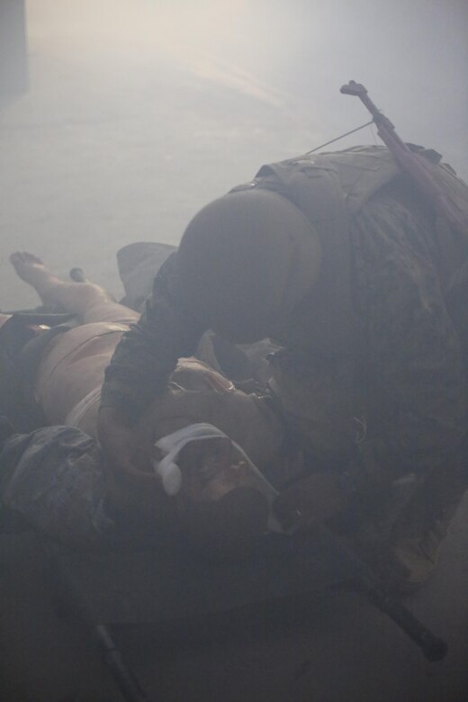 U.S. Navy Seaman Andre Hall, a hospitalman with 2nd Medical Battalion, treats a casualty during a tactical combat casualty care exercise at Camp Lejeune, N.C., Feb. 12, 2016. Sailors were challenged by a chaotic environment of smoke and loud, sporadic noises. (U.S. Marine Corps photo by Cpl. Paul S. Martinez/Released)