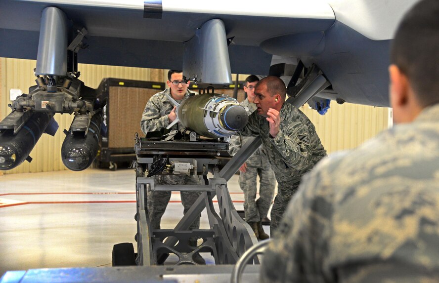 Airmen from the 27th Special Operations Maintenance Squadron MQ-9/CV-22 armament unit load an inert GBU-38 on an MQ-9 Reaper during Cannon’s annual load competition Feb. 5, 2016, at Cannon Air Force Base, N.M. Both teams moved quickly in an attempt to claim victory during the second consecutive competition. (U.S. Air Force photo/Staff Sgt. Alexx Pons) 