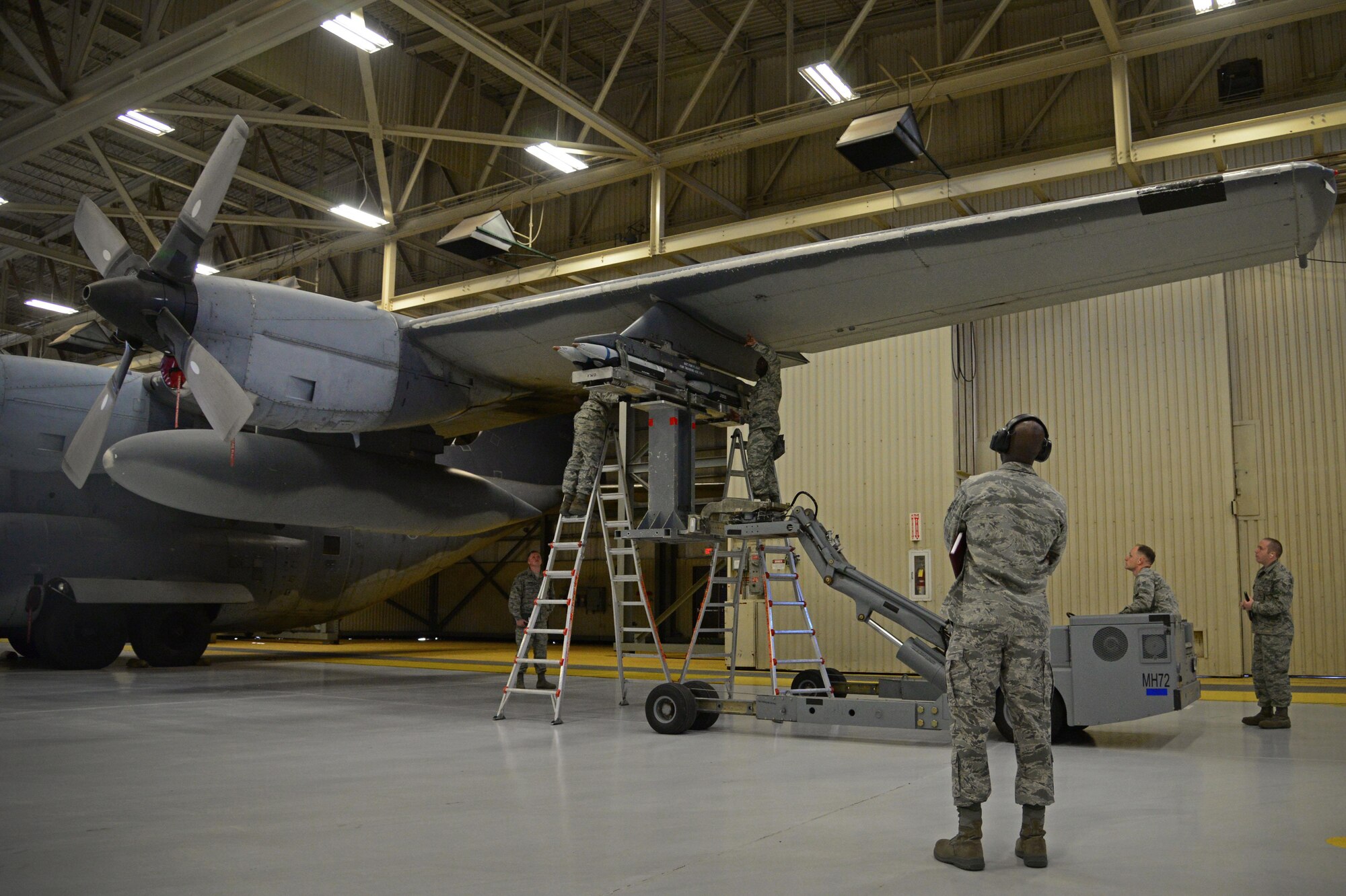 Airmen from the 27th Special Operations Maintenance Squadron AC-130W armament unit load an inert GBU-39 on an AC-130 trainer during an annual load competition Feb. 5, 2016, at Cannon Air Force Base, N.M. Teams worked quickly in an attempt to claim victory during the second consecutive competition. (U.S. Air Force photo/Staff Sgt. Alexx Pons) 