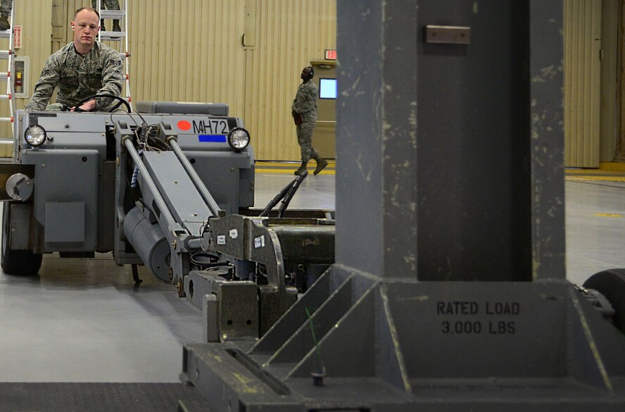 Airman 1st Class Nathanael Butterfield, 27th Special Operations Maintenance Squadron AC-130W armament unit, maneuvers an MHU-83 and loading extension during an annual load competition Feb. 5, 2016, at Cannon Air Force Base, N.M. Crews worked diligently to showcase skills during the second consecutive competition. (U.S. Air Force photo/Staff Sgt. Alexx Pons) 