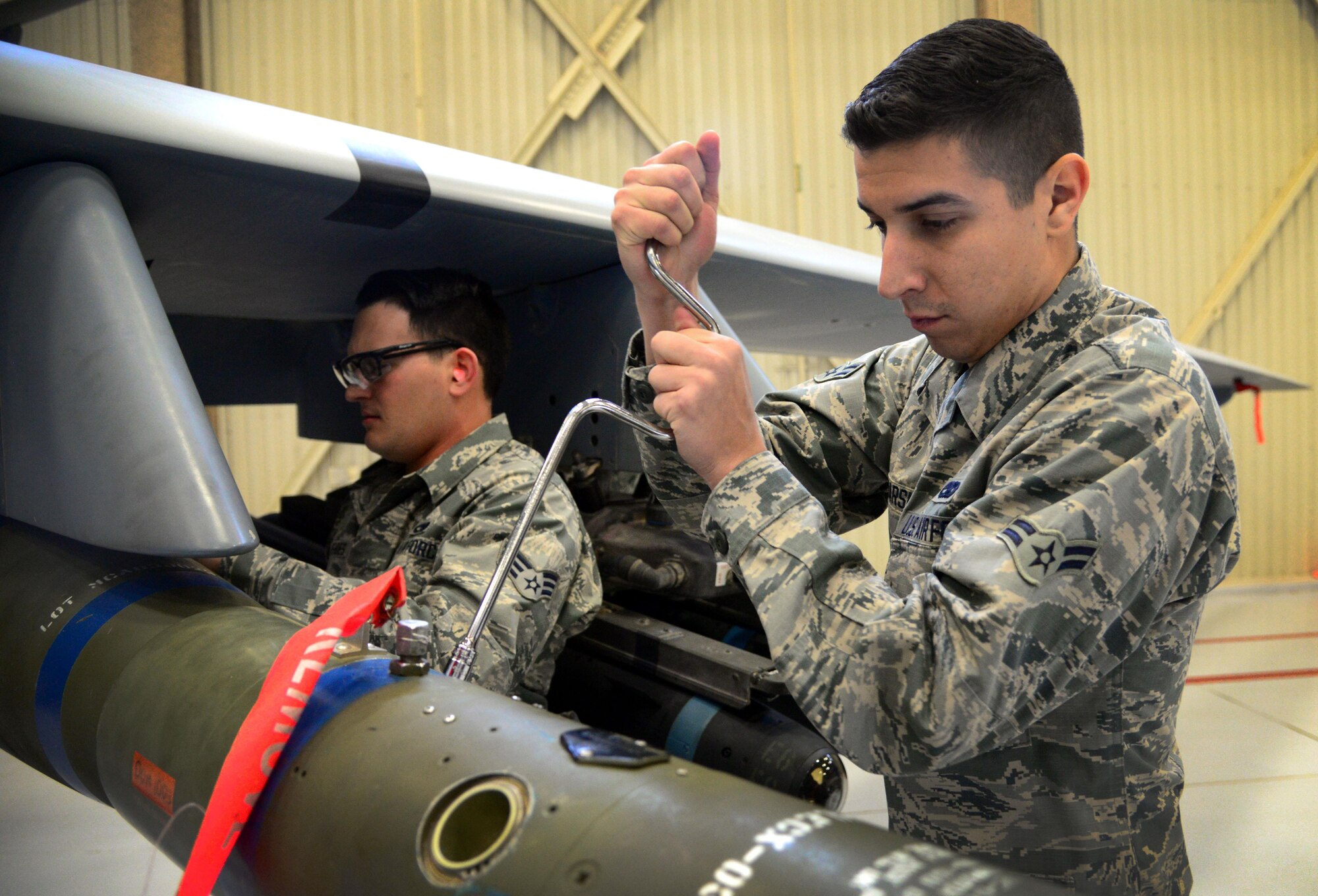 Airman 1st Class Jonathan Marsico, 27th Special Operations Maintenance Squadron MQ-9/CV-22 armament unit, works to secure an inert GBU-12 during an annual load competition Feb. 5, 2016, at Cannon Air Force Base, N.M. Both teams worked diligently to showcase skills during the second consecutive competition. (U.S. Air Force photo/Staff Sgt. Alexx Pons) 