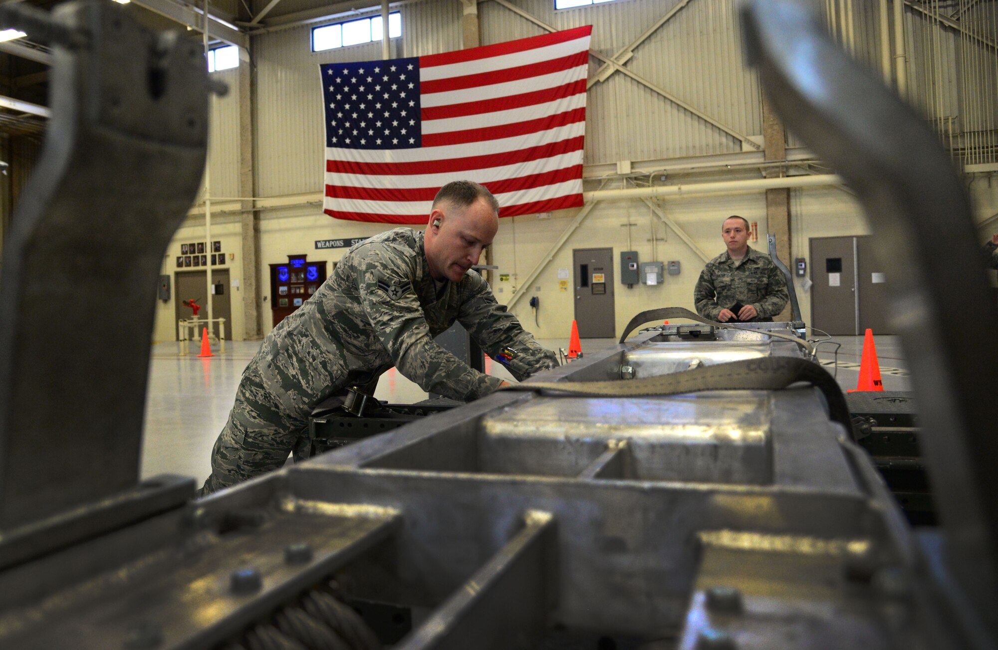 Airman 1st Class Nathanael Butterfield, 27th Special Operations Maintenance Squadron AC-130W armament unit, secures a BRU-61 cradle during an annual load competition Feb. 5, 2016, at Cannon Air Force Base, N.M. Inspections and functional checks are a critical component of loading aircraft. (U.S. Air Force photo/Staff Sgt. Alexx Pons) 