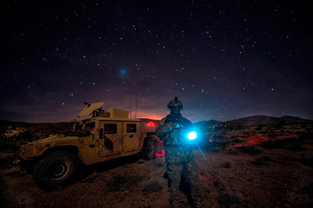 A soldier provides security during a convoy halt at the National Training Center on Fort Irwin, Calif., Feb. 12, 2016. The soldier is assigned to the 1st Cavalry Division's 3rd Cavalry Regiment. Army photo by Staff Sgt. Alex Manne