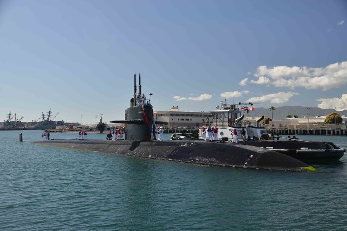 PEARL HARBOR (Feb. 12, 2016) Sailors and officers stand topside aboard the Los Angeles-class fast-attack submarine USS City of Corpus Christi (SSN 705) as she prepares to moor returning home to Pearl Harbor after completing her final scheduled deployment to the Western Pacific Ocean. (U.S. Navy photo by Mass Communication Specialist 1st Class Jason Swink/Released)