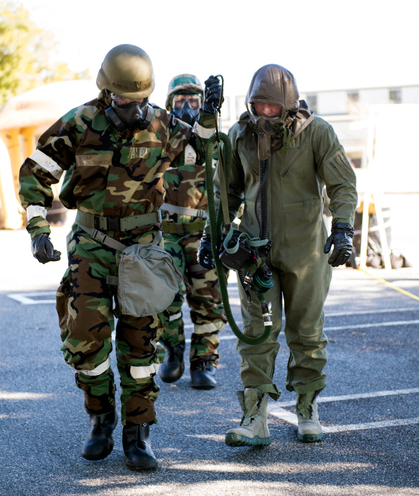 U.S. Air Force Airman Austin Johnson, 347th Operations Support Squadron aircrew flight equipment technician, assists Senior Airman John Kennedy, 347th OSS AFE technician, with his aircrew eye and respiratory protection equipment assembly during Aircrew Contamination Control Area training, Feb. 11, 2016, at Moody Air Force Base, Ga. The AERP is the aircrew’s equivalent to mission-oriented protective posture (MOPP) level-4 gear to protect them from chemical, biological, radiological, and nuclear environments. (U.S. Air Force photo by Airman 1st Class Greg Nash/Released) 