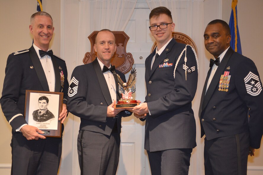 U.S. Air Force Senior Airman Ian Patterson, 3rd Intelligence Squadron, receives the John L. Levitow Award for the Senior Master Sgt. David B. Reid Airman Leadership School Class 16-2, from Chief Master Sgt. Delbert Areford, 20th Maintenance Group superintendent, at Shaw Air Force Base, S.C., Feb. 11, 2016. The Airman with the highest average of instructor and student points receives the Levitow Award, which is the highest award in enlisted professional military education. (U.S. Air Force photo by Senior Airman Diana M. Cossaboom)
