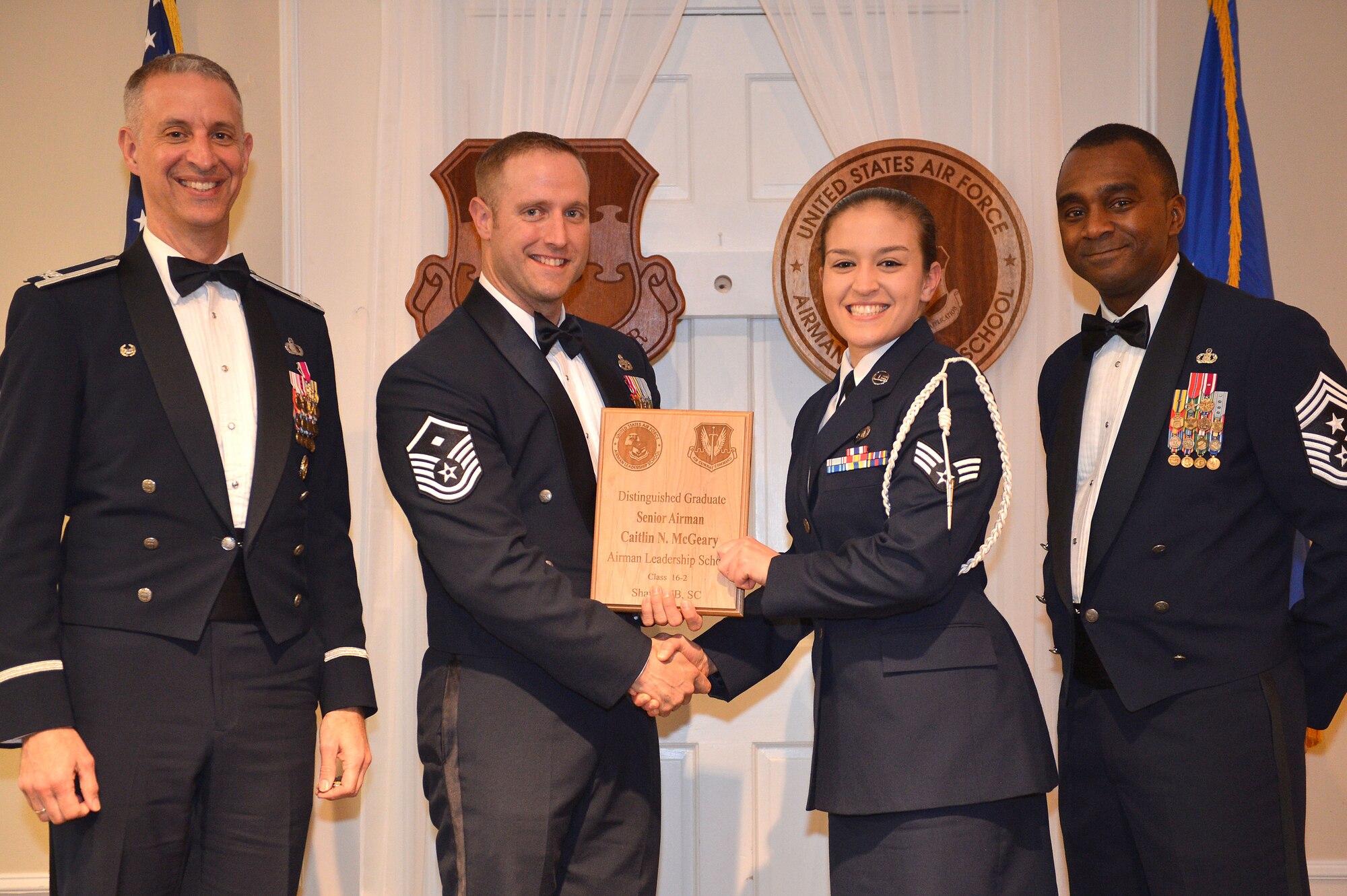 U.S. Air Force Senior Airman Caitlin McGeary, 3rd Intelligence Squadron, receives a Distinguished Graduate Award for the Senior Master Sgt. David B. Reid Airman Leadership School Class 16-2 from Master Sgt. William Byrd, 20th Force Support Squadron first sergeant, at Shaw Air Force Base, S.C., Feb. 11, 2016. Only Airmen in the top 10 percent of the class graduate with this prestigious award. (U.S. Air Force photo by Senior Airman Diana M. Cossaboom)
