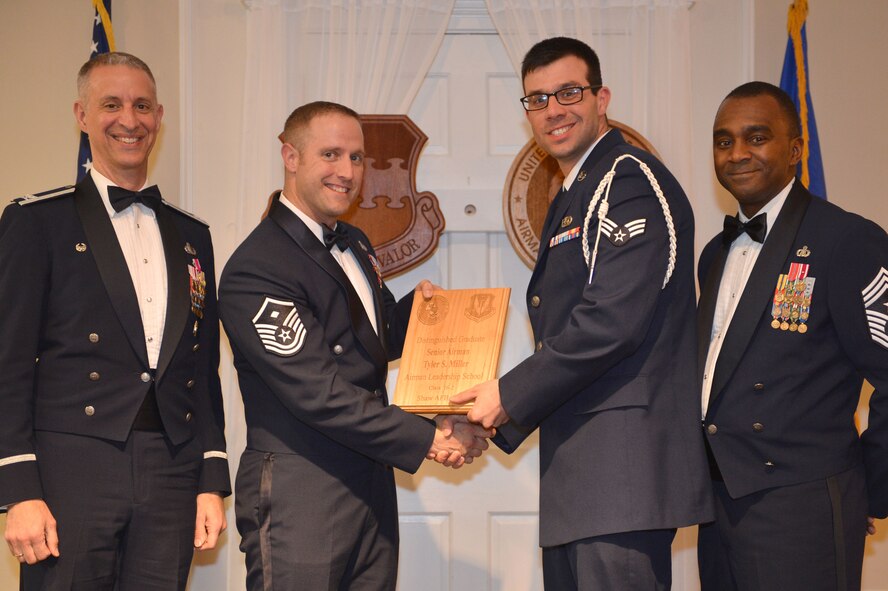 U.S. Air Force Senior Airman Tyler Miller, 3rd Intelligence Squadron, receives a Distinguished Graduate Award for the Senior Master Sgt. David B. Reid Airman Leadership School Class 16-2 from Master Sgt. William Byrd, 20th Force Support Squadron first sergeant, at Shaw Air Force Base, S.C., Feb. 11, 2016. Only Airmen in the top 10 percent of the class graduate with this prestigious award. (U.S. Air Force photo by Senior Airman Diana M. Cossaboom)