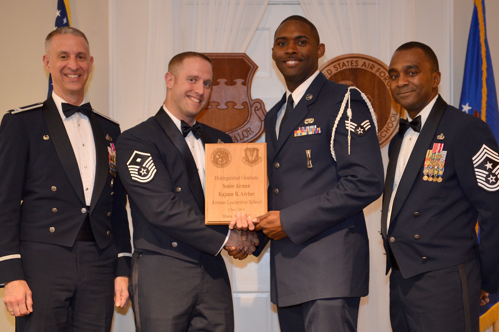 U.S. Air Force Senior Airman Kajuan Archer, 169th Aircraft Maintenance Squadron, receives a Distinguished Graduate Award for the Senior Master Sgt. David B. Reid Airman Leadership School Class 16-2 from Master Sgt. William Byrd, 20th Force Support Squadron first sergeant, at Shaw Air Force Base, S.C., Feb. 11, 2016. Only Airmen in the top 10 percent of the class graduate with this prestigious award. (U.S. Air Force photo by Senior Airman Diana M. Cossaboom)