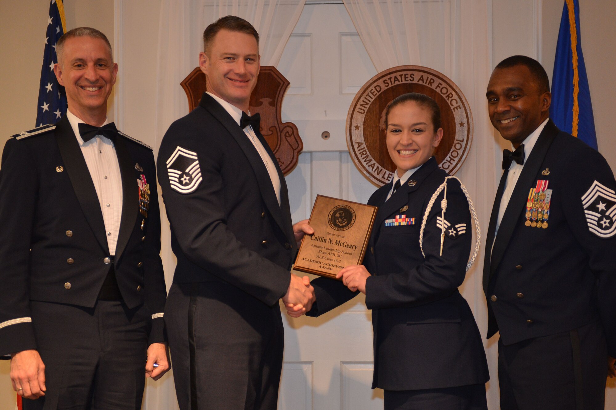 U.S. Air Force Senior Airman Caitlin McGeary, 3rd Intelligence Squadron, receives the Senior Master Sgt. David B. Reid Airman Leadership School Academic Achievement Award from Senior Master Sgt. Jacob Peeterse, 20th Component Maintenance Squadron maintenance superintendent, during the ALS Class 16-2 graduation at Shaw Air Force Base, S.C., Feb. 11, 2016. The student with the highest point total earns this award. (U.S. Air Force photo by Senior Airman Diana M. Cossaboom)