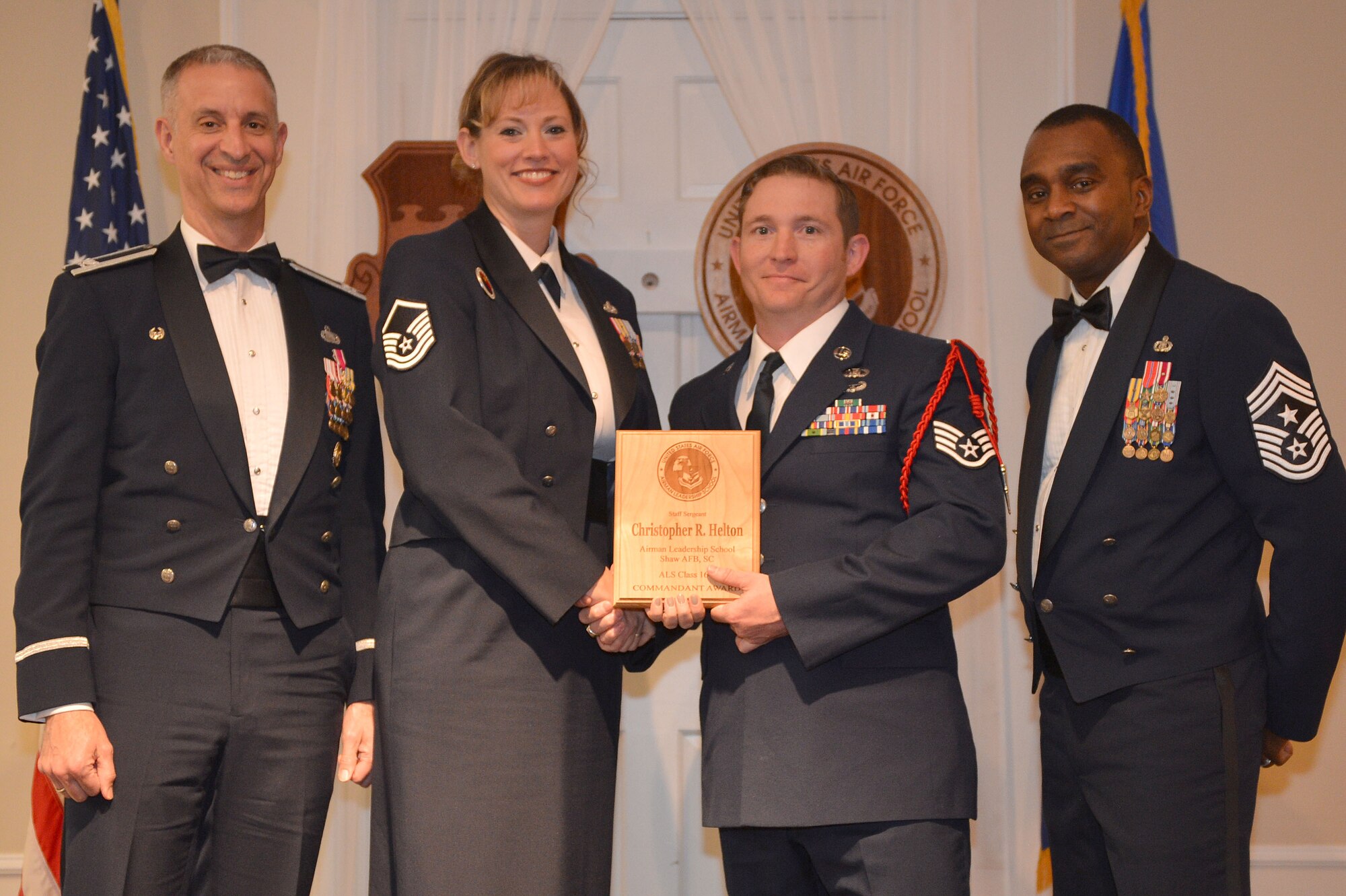 U.S. Air Force Staff Sgt. Christopher Helton, 15th Air Support Operations Squadron, receives the Senior Master Sgt. David B. Reid Airman Leadership School Commandant’s Award from Master Sgt. Lindsey Wolf, 20th Force Support Squadron ALS commandant, during the ALS Class 16-2 graduation at Shaw Air Force Base, S.C., Feb. 11, 2016. The Commandant’s award is given to the student who most exemplifies professional military qualities as chosen by their peers, the primary instructors, and the ALS commandant. (U.S. Air Force photo by Senior Airman Diana M. Cossaboom)