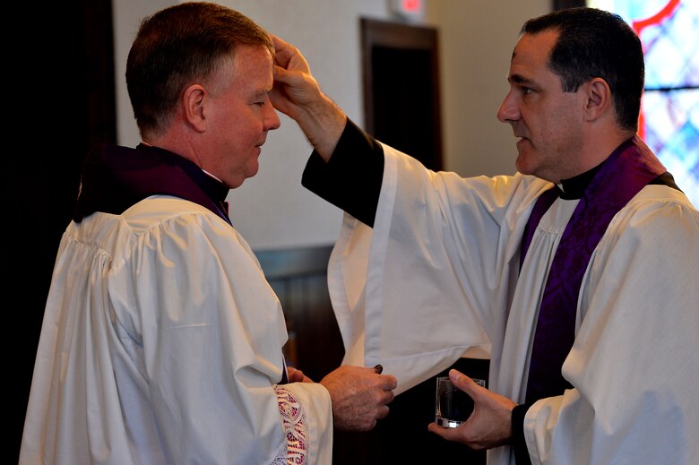 U.S. Air Force Chaplain (Capt.) James Finley, 20th Fighter Wing chaplain, rubs ashes on the forehead of Monsignor Mark Rowan, 20th FW catholic priest, during an Ash Wednesday service at the Friendship Chapel at Shaw Air Force Base, S.C., Feb. 10, 2016. Maintaining ones spiritual resiliency is an integral part of Comprehensive Airman Fitness. (U.S. Air Force photo by Senior Airman Michael Cossaboom)