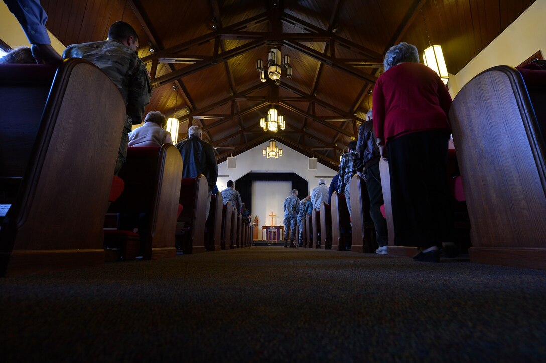 Members of Team Shaw stand for an Ash Wednesday service at the Friendship Chapel at Shaw Air Force Base, S.C., Feb. 10, 2016. Ash Wednesday represents a time of renewal and repentance. (U.S. Air Force photo by Senior Airman Michael Cossaboom)