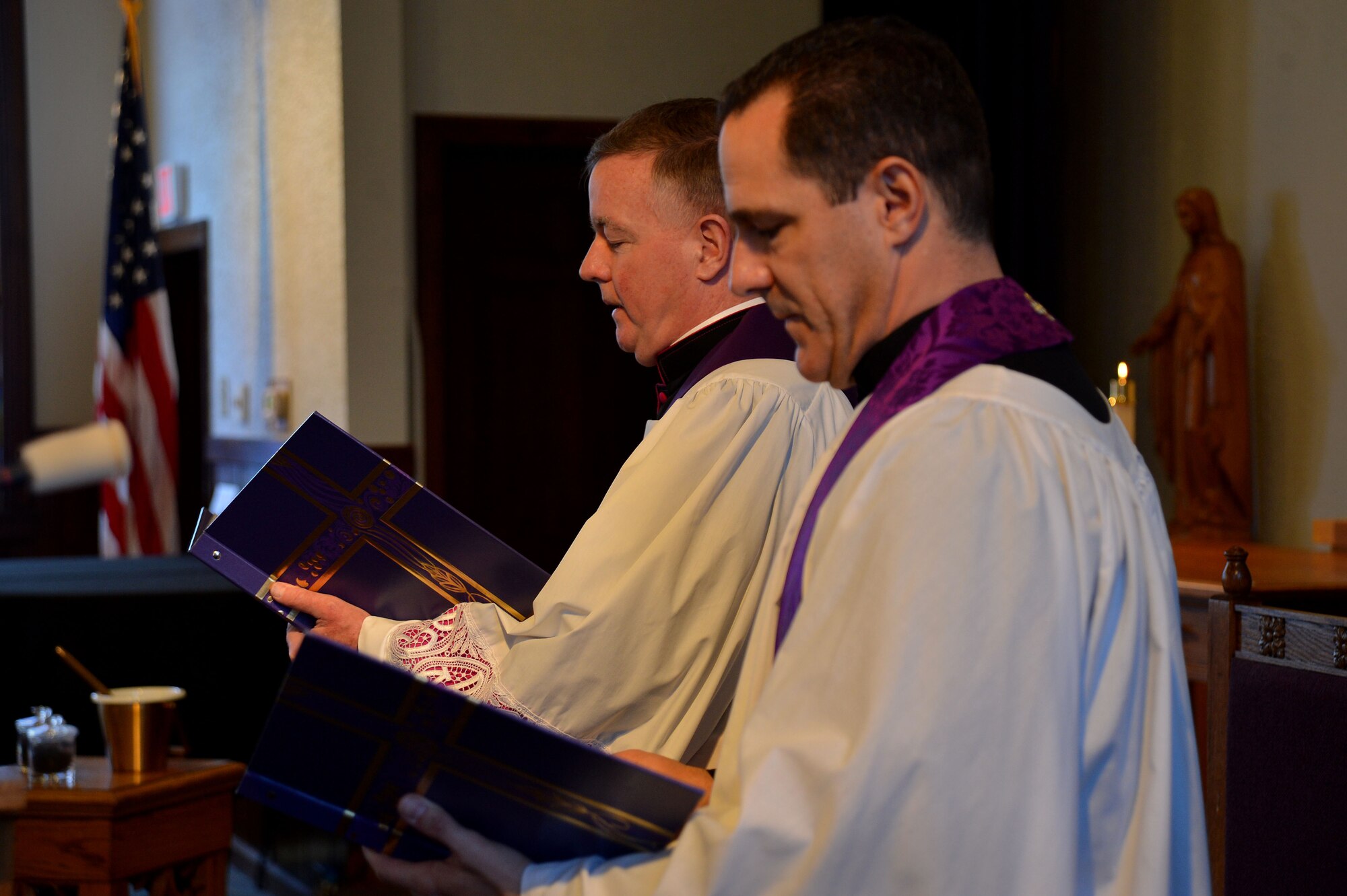 U.S. Air Force Chaplain (Capt.) James Finley, 20th Fighter Wing chaplain, and Monsignor Mark Rowan, 20th FW catholic priest, speak to members of Team Shaw during an Ash Wednesday service at the Friendship Chapel at Shaw Air Force Base, S.C., Feb. 10, 2016. Ash Wednesday marks the official beginning of Lent. (U.S. Air Force photo by Senior Airman Michael Cossaboom)