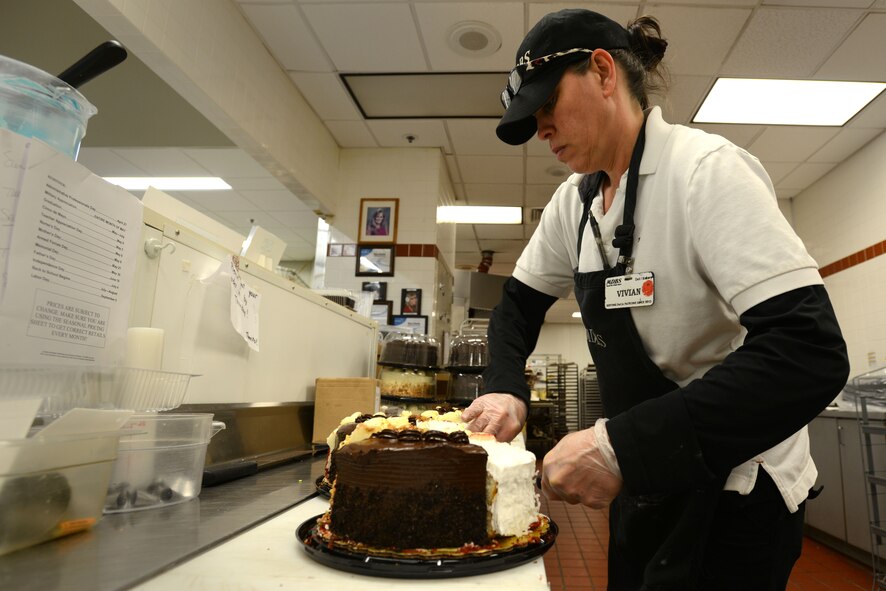 A Military Deli Bakery Services employee arranges a cake in the commissary at Shaw Air Force Base, S.C., Feb. 16, 2016. The bakery offers a wide variety of cakes and other pastries for different occasions, such as holidays or birthdays. (U.S. Air Force photo by Airman 1st Class Kelsey Tucker)