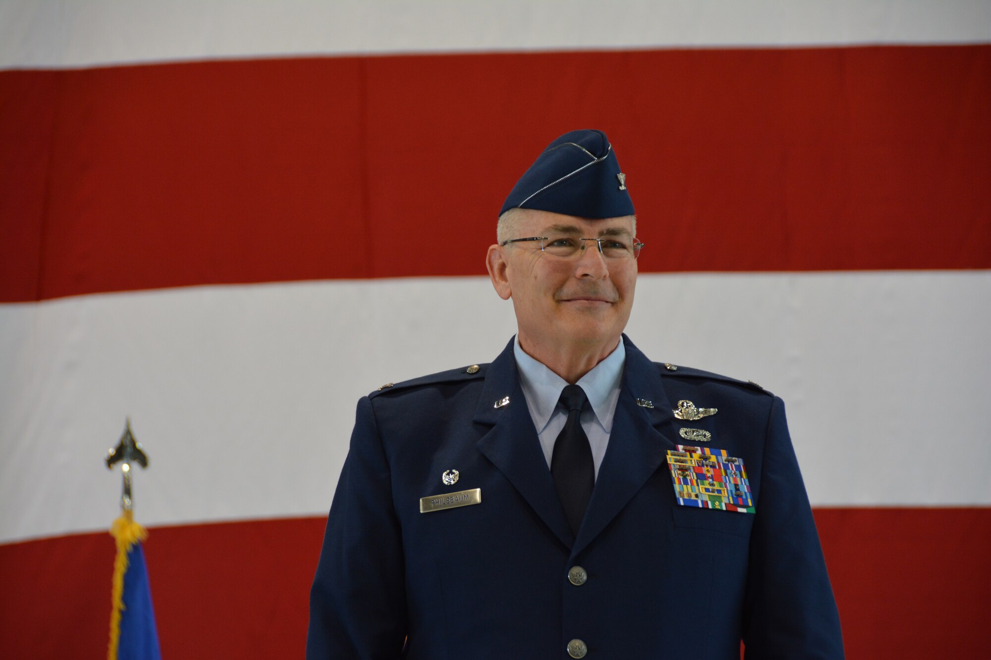 Col. Jonathan Philebaum takes the stage to address the men and women of the 932d Airlift Wing during the unit's change of command ceremony, which took place Feb. 7, 2016 at Scott Air Force Base, Illinois. (U.S. Air Force photo by Tech. Sgt. Jodi Ames)