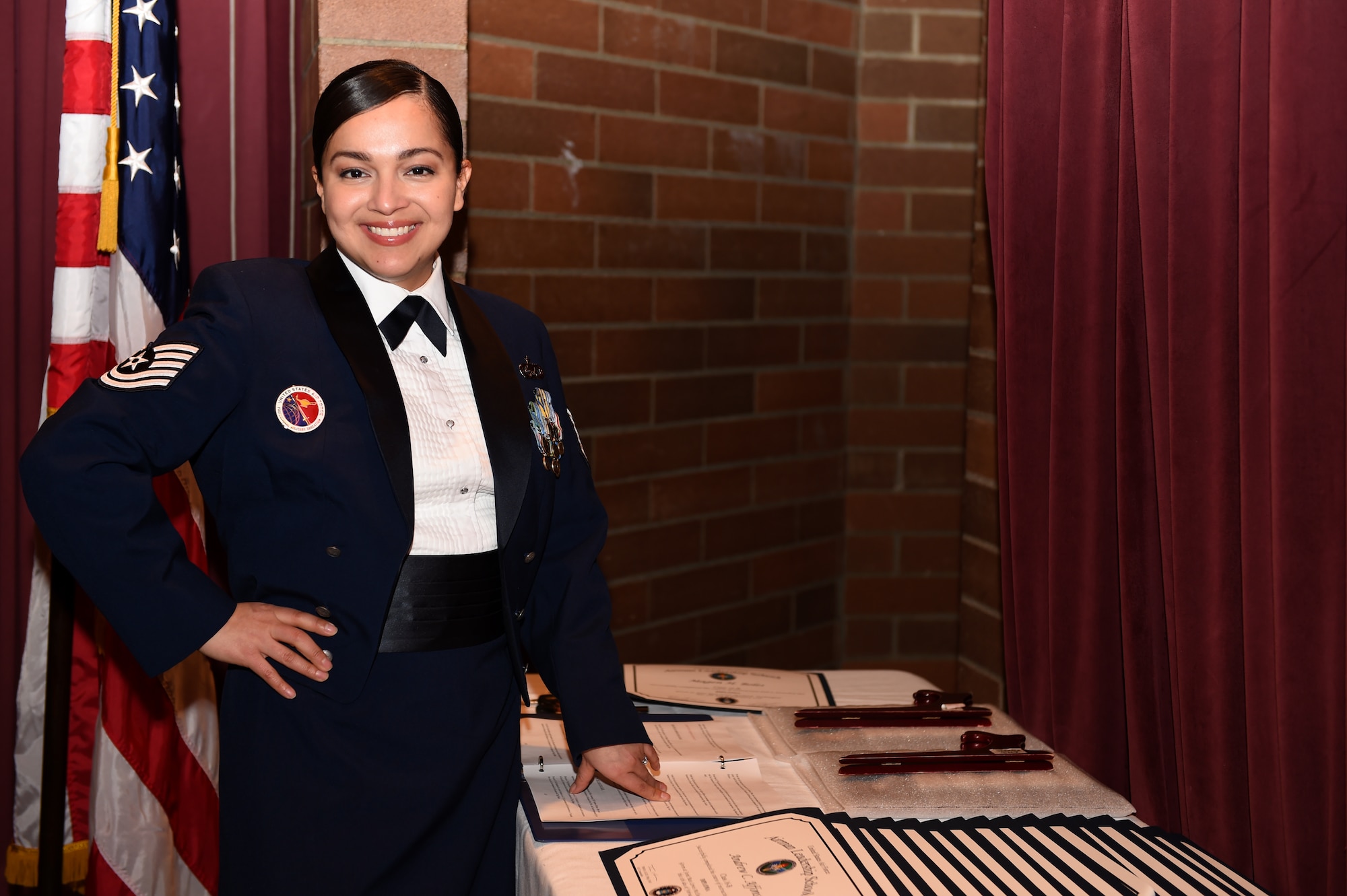 Tech. Sgt. Justine Doyle, Julius A. Kolb Airman Leadership instructor, prepares certificates during the ALS graduation at Joint Base Lewis-McChord, Wash., Feb. 11, 2016. Doyle has spent the last four years instructing new non-commissioned officers on professional military education. (U.S. Air Force photo/Staff Sgt. Naomi Shipley)