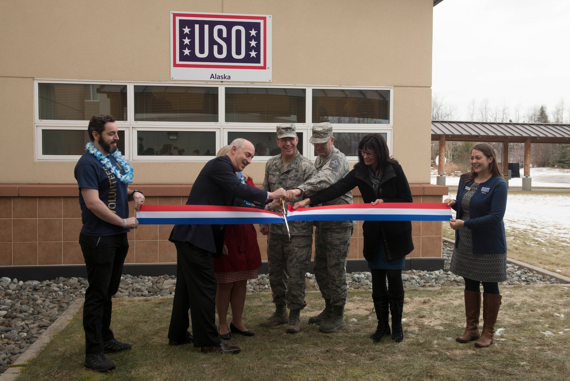 Service members celebrate the grand opening of the latest USO facility, Feb 11, at Joint Base Elmendorf-Richardson, Alaska. The USO has served military members and their families for approximately 75 years as they transition assignments and deployments. (U.S. Air Force photo by Tech. Sgt. Raymond Mills)