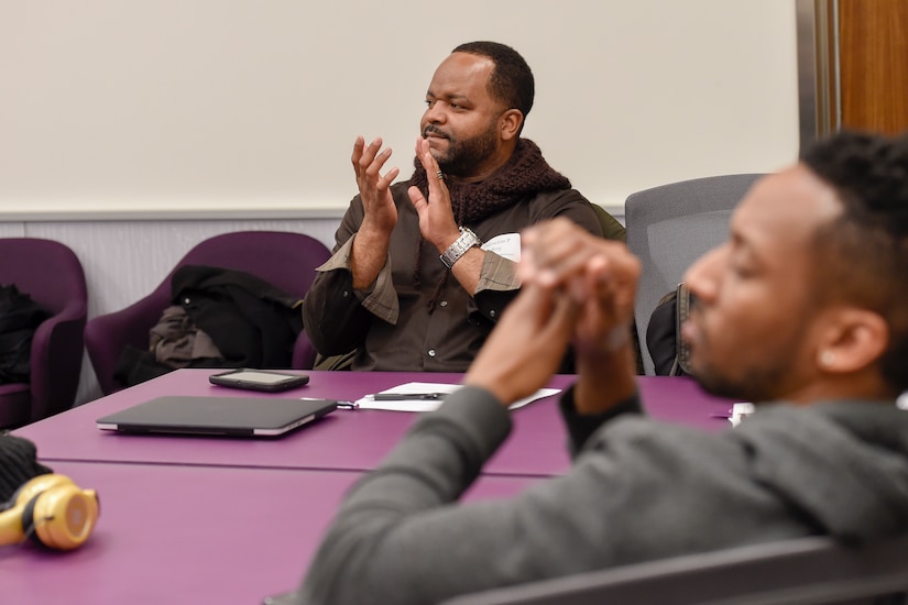 Dameion Roy, Roosevelt High School music teacher, applauds during a performance by members of the U.S. Air Force Airmen of Note jazz ensemble during a professional development training held at the National Museum of American History in Washington, D.C., Feb. 12, 2016. The training was held for District of Columbia Public Schools’ music teachers. (U.S. Air Force photo/Senior Airman Ryan J. Sonnier/RELEASED)