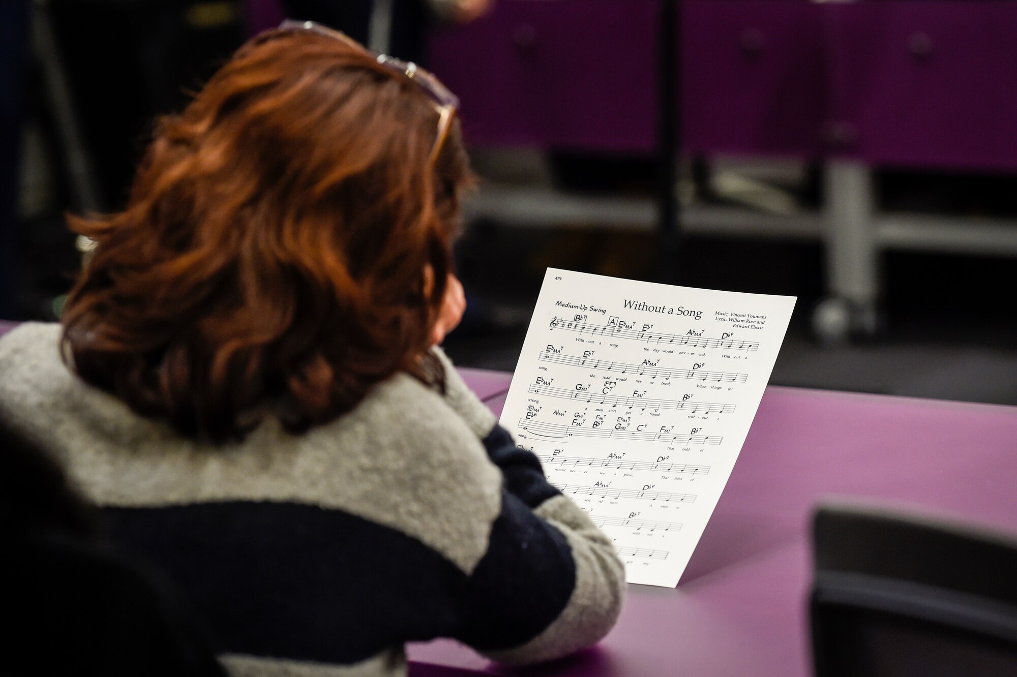 A District of Columbia Public School teacher reads sheet music during a performance by members of the U.S. Air Force Airmen of Note jazz ensemble during a professional development training held at the National Museum of American History in Washington, D.C., Feb. 12, 2016. (U.S. Air Force photo/Senior Airman Ryan J. Sonnier/RELEASED)