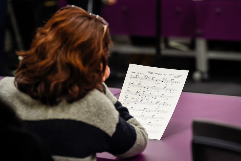 A District of Columbia Public School teacher reads sheet music during a performance by members of the U.S. Air Force Airmen of Note jazz ensemble during a professional development training held at the National Museum of American History in Washington, D.C., Feb. 12, 2016. (U.S. Air Force photo/Senior Airman Ryan J. Sonnier/RELEASED)