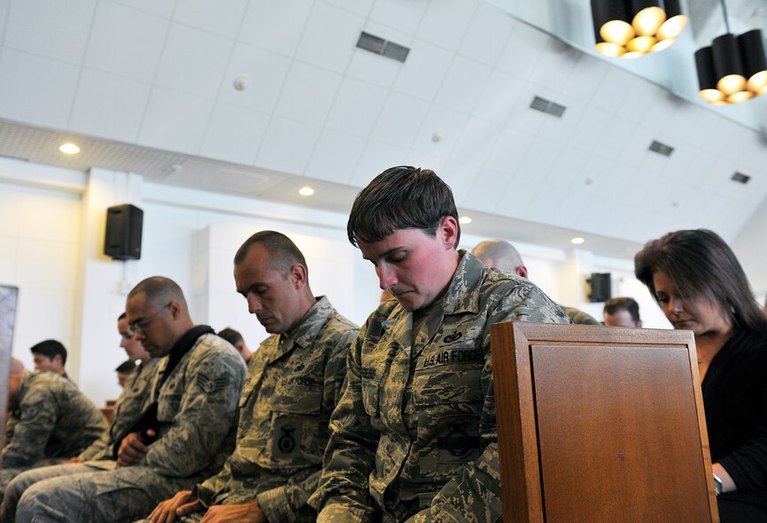 U.S. Air Force Airmen observe a moment of silence for Military Working Dog Rob during a memorial at Chapel 1, Feb. 10, 2016, at Kadena Air Base, Japan. Rob, who served for more than three years with the U.S. Air Force as a patrol explosive detection dog, passed away Jan. 7, 2016. (U.S. Air Force photo by Naoto Anazawa)
