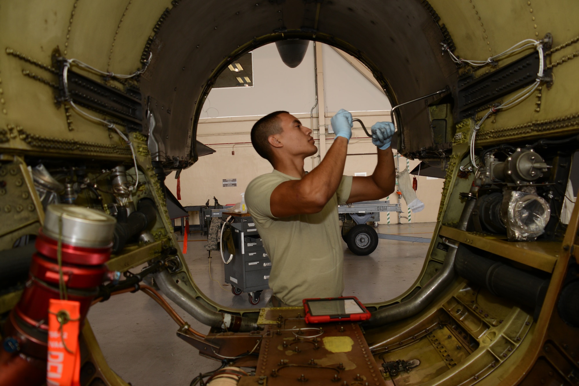 Senior Airman Gylmar Garcia, a 482nd Maintenance Squadron mechanic, removes heat-shielding panels inside a F-16 Fighting Falcon Feb. 7 at Homestead Air Reserve Base, Florida. (U.S. Air Force photo/Senior Airman Frank Casciotta) 