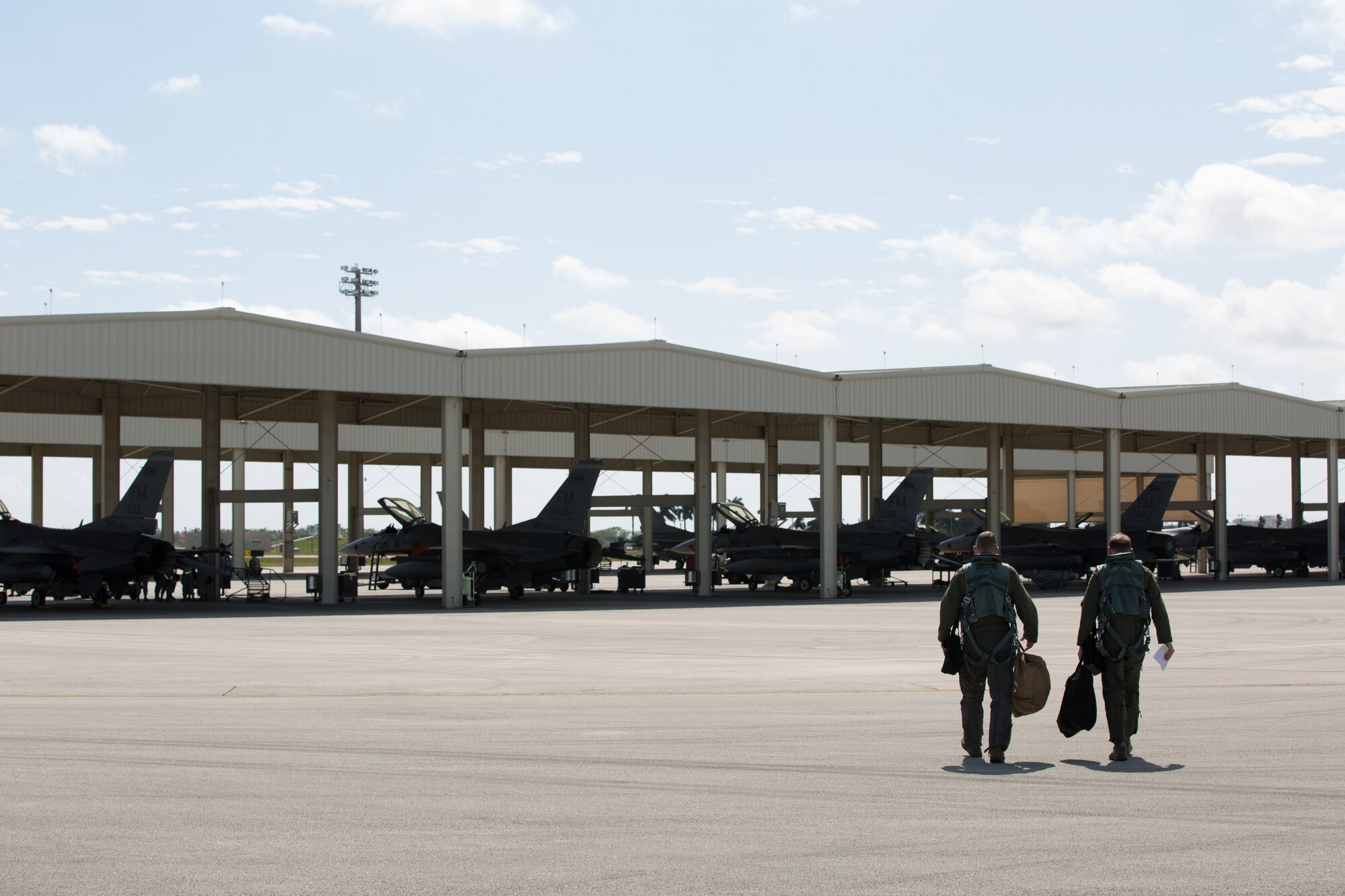 Two F-16 Fighting Falcon pilots with the 93rd Fighter Squadron walk toward their aircrafts during the Feb. 6 during the Unit Training Assembly at Homestead Air Reserve Base, Florida. (U.S. Air Force photo/Tech. Sgt. Lionel Castellano) 